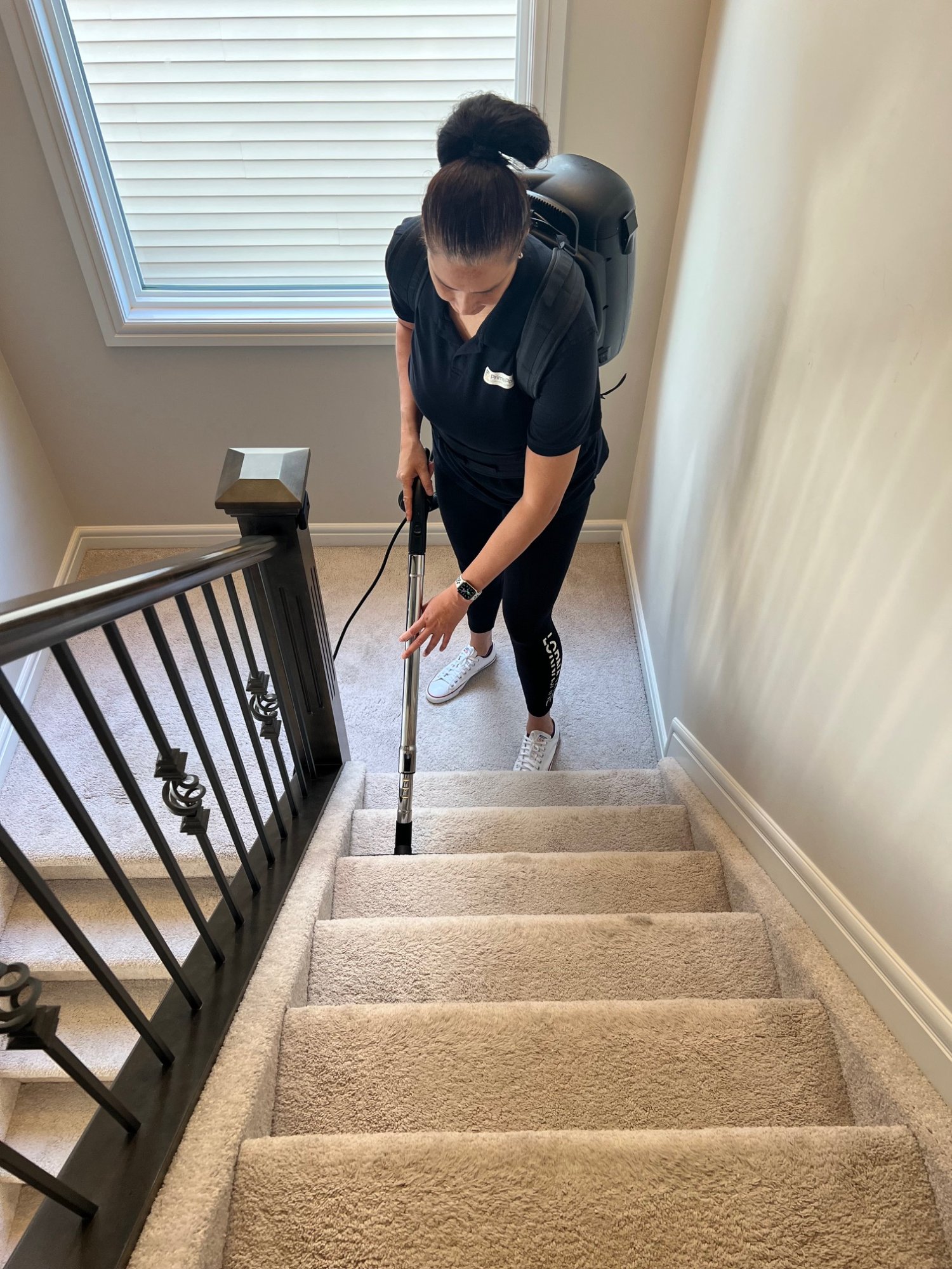PrimePoint team vacuuming stairs with HEPA backpack